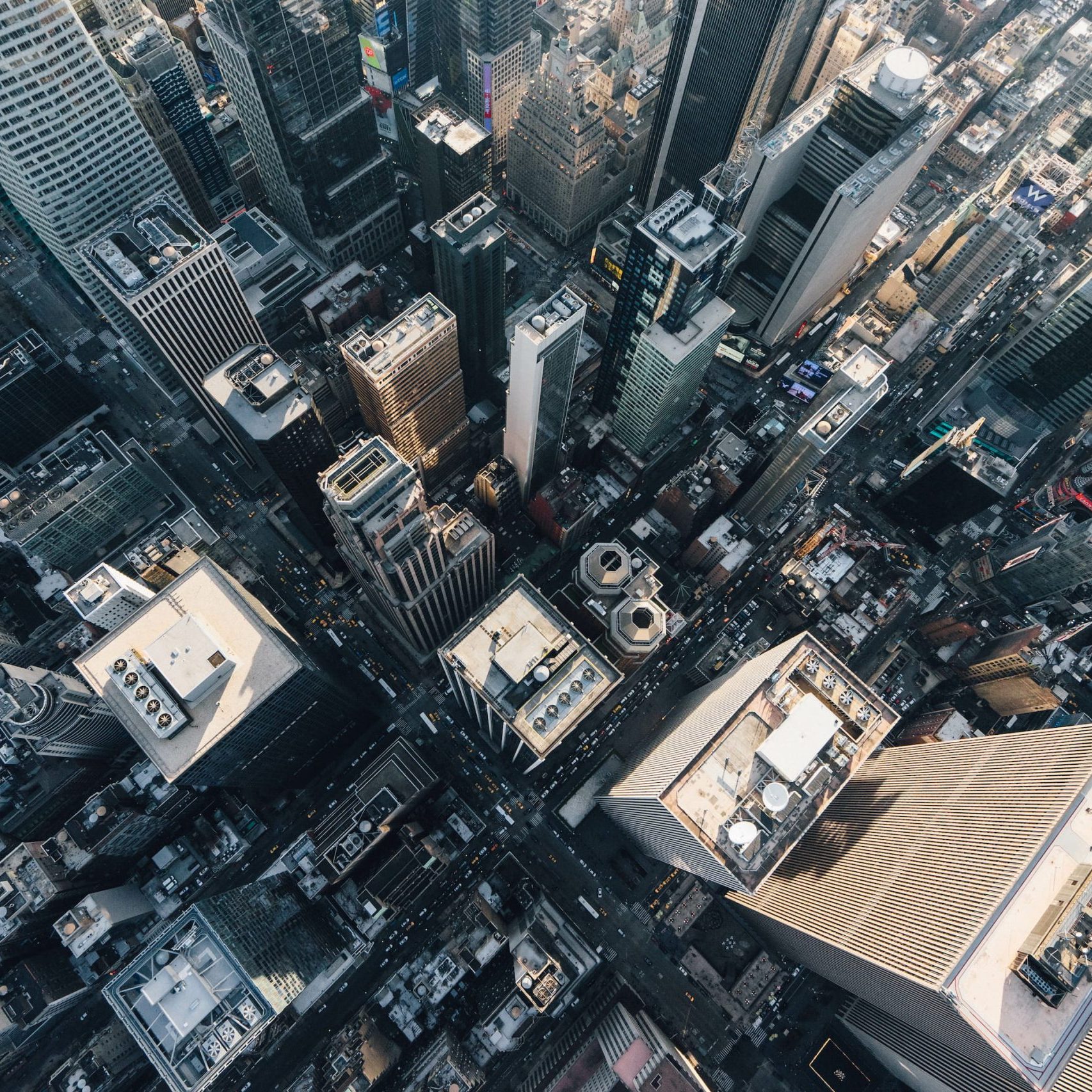 Aerial view of densely packed skyscrapers and streets in an IoT smart cityscape.